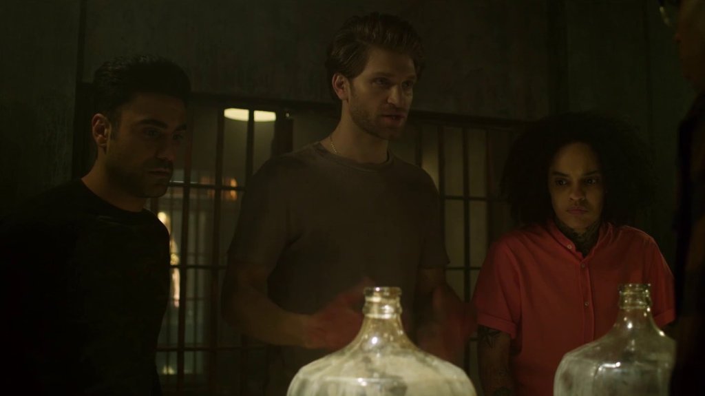 Cole (Keegan Allen) and his friends Dash (George Janko) and Sam (Siya) trying to figure out one of the escape room puzzles. 