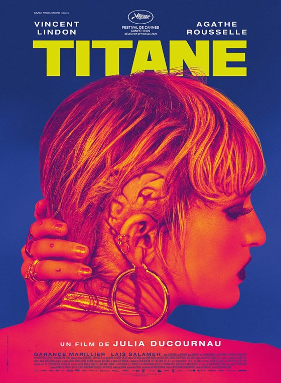 The film poster showing Alexia (Agathe Rousselle) pushing back her hair to reveal a large, snail-shaped scar behind her ear.