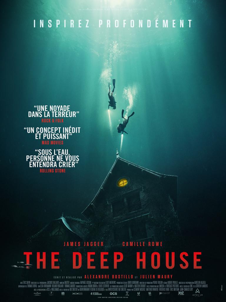 The film poster showing two divers approaching a submerged house. There's a light in one of the windows of the house.