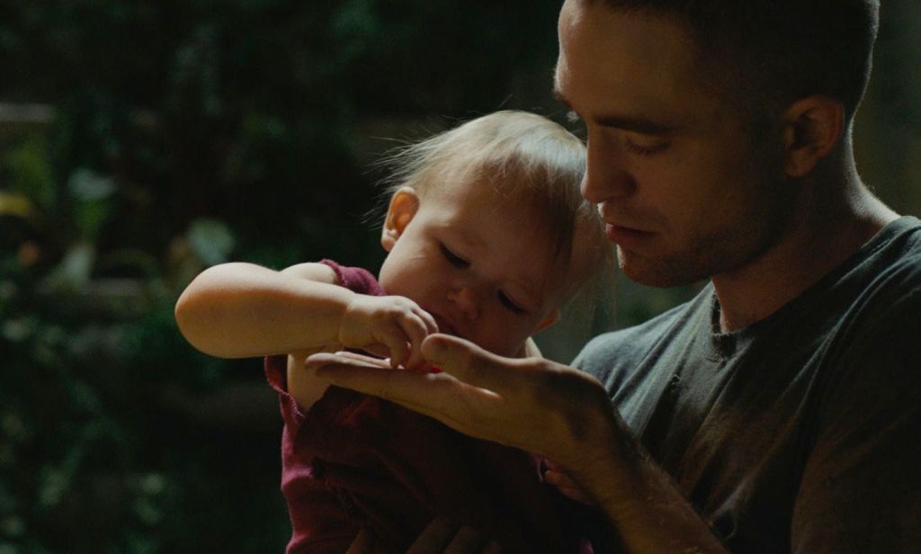 Monte (Robert Pattinson) with Willow (Scarlett Lindsey) in the garden. 